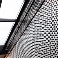 metal lattice wall and overhead light in underpass photo