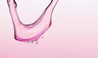 pink liquid splash on pink background photo