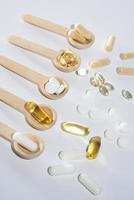 Spoons with vitamins, Vitamin D, omega 3, omega 6, Food supplement oil filled fish oil, vitamin A, vitamin E, flaxseed oil photo