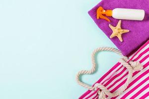 Summer bag background with copy space. Flat lay photo on color table, travel concept. Free space for text, mock-up