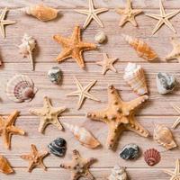 Starfish and seashells background on a wooden table, top view, flat lay photo