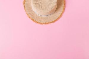 yellow retro straw hat top view with copy space. summer concept on pink background photo