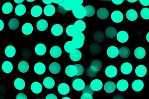 Unfocused abstract colourful bokeh black background. defocused and blurred many round blue light photo