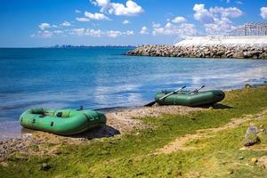 Rubber boat on the sea shore. Rubber inflatable boat for fishing photo