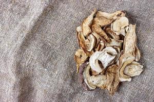 dried mushroom on sackcloth. Top view dried porcini mushrooms photo