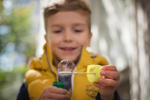 Close up of child blowing bubbles. photo