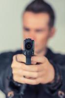 Close up of man aiming with handgun. photo