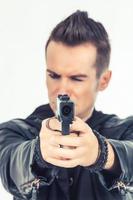 Close up of man aiming with a gun. photo