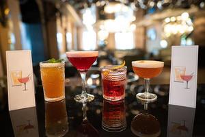 beautiful and delicious alcoholic cocktails prepared at the bar by the bartender. photo