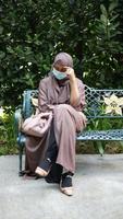 Thoughtful muslim woman sitting on park video