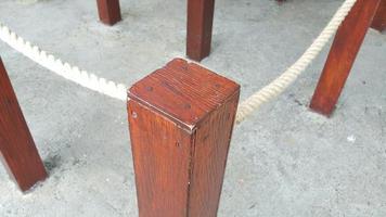 Close up of rope with wooden poles on concrete floor photo