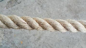 Close up of ropes with concrete floor in background photo