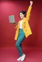 Full length image of young Asian business woman on background photo