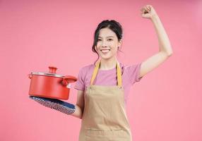 Young Asian woman housewife on background photo