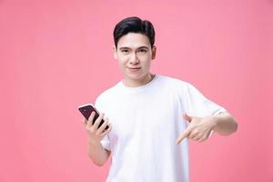 Young Asian man using smartphone on background photo