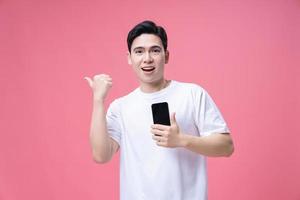 Young Asian man using smartphone on background photo
