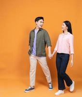 Young Asian couple standing on background photo