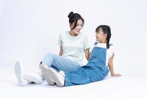 Image of Asian mother and daughter on background photo