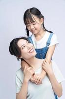 Image of Asian mother and daughter on background photo
