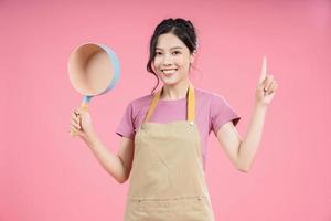 Young Asian woman housewife on background photo