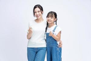 Image of Asian mother and daughter on background photo