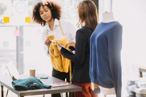 Startup SME small business entrepreneur of freelance Asian woman wearing apron using laptop and box to receive and review orders online to prepare to pack sell to customers, online sme business ideas. photo