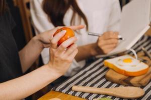 Young woman eating pizza and laughing while sitting with her friends in a restaurant. Group of friends enjoying while having food and drinks at cafe. photo