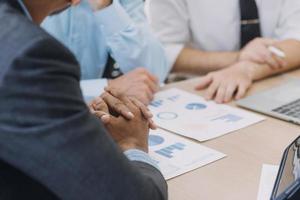 Financial analysts analyze business financial reports on a digital tablet planning investment project during a discussion at a meeting of corporate showing the results of their successful teamwork. photo