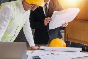 Architect concept, Architects working with blueprints in the office, Vintage Effect photo