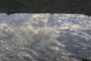 white clouds and sun against a background of blue sky photo