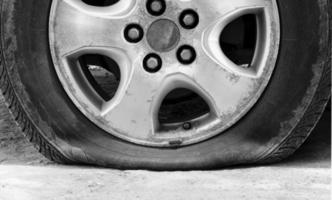 Close up wheel car and leaking tire photo