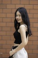 Portrait of hipster girl  on brick wall background,Beautiful asian woman pose for take a photo,Kawaii style photo