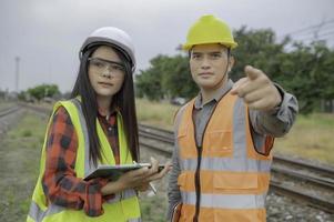 Two engineer working at train station,Work together happily,Help each other analyze the problem,Consult about development guidelines photo