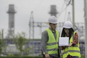 Two engineer working at power plant,Work together happily,Help each other analyze the problem,Consult about development guidelines photo