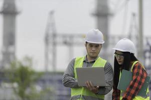 Two engineer working at power plant,Work together happily,Help each other analyze the problem,Consult about development guidelines photo