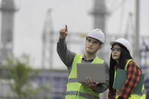Two engineer working at power plant,Work together happily,Help each other analyze the problem,Consult about development guidelines photo
