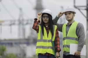 Two engineer working at power plant,Work together happily,Help each other analyze the problem,Consult about development guidelines photo