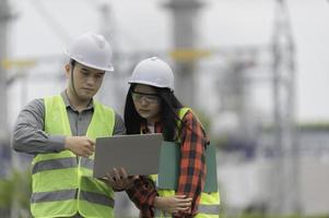 Two engineer working at power plant,Work together happily,Help each other analyze the problem,Consult about development guidelines photo