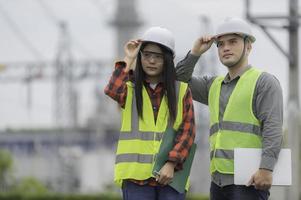 Two engineer working at power plant,Work together happily,Help each other analyze the problem,Consult about development guidelines photo
