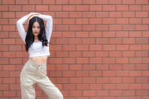 Portrait of hipster girl  on brick wall background,Beautiful asian woman pose for take a photo,Kawaii style photo