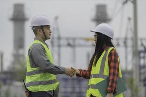 Two engineer working at power plant,Work together happily,Help each other analyze the problem,Consult about development guidelines photo