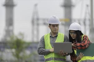 Two engineer working at power plant,Work together happily,Help each other analyze the problem,Consult about development guidelines photo