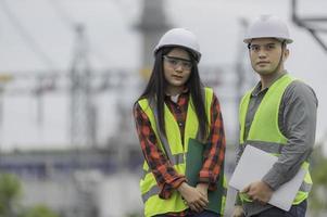 Two engineer working at power plant,Work together happily,Help each other analyze the problem,Consult about development guidelines photo