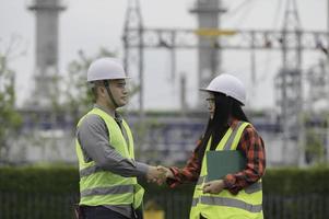 Two engineer working at power plant,Work together happily,Help each other analyze the problem,Consult about development guidelines photo