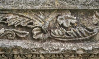 Details of carved stones on the top of the portico, beautiful stone carvings, history and heritage of ancient civilizations, details of a temple in the Aegean region of Turkey photo