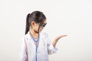 Asia little girl playing doctor isolated on white photo