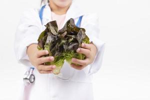 Asia little girl playing doctor isolated on white photo