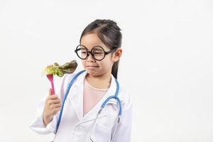 Asia little girl playing doctor isolated on white photo