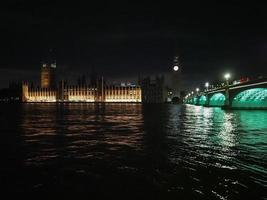 Houses of Parliament and Westminster Bridge at night in London photo