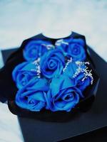 blue rose and sweet light line in gift box with bear doll photo